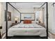 Comfortable main bedroom featuring a decorative canopy bed with a tray ceiling at 7191 Old Melbourne Hwy, St Cloud, FL 34771