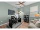 Well-lit office space with a dark desk, chair, hardwood floors, and a decorative hutch at 7191 Old Melbourne Hwy, St Cloud, FL 34771