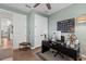 Another view of well-lit office space with a dark desk, chair, and hardwood floors at 7191 Old Melbourne Hwy, St Cloud, FL 34771