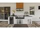 This outdoor kitchen features a built-in grill, stainless steel appliances, and granite countertops at 7191 Old Melbourne Hwy, St Cloud, FL 34771