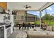 Screened patio with outdoor kitchen, dining area, and comfortable seating at 7191 Old Melbourne Hwy, St Cloud, FL 34771