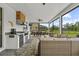 Covered patio with outdoor kitchen, dining area, and comfortable seating at 7191 Old Melbourne Hwy, St Cloud, FL 34771