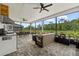 Screened patio with outdoor kitchen, dining area, and comfortable seating at 7191 Old Melbourne Hwy, St Cloud, FL 34771