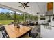 Large screened patio with a dining table, an outdoor kitchen, and a cozy seating area at 7191 Old Melbourne Hwy, St Cloud, FL 34771