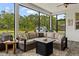 Inviting screened patio with comfortable seating area, ceiling fan and view of the lush backyard at 7191 Old Melbourne Hwy, St Cloud, FL 34771