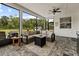 Inviting screened patio with comfortable seating area, ceiling fan and view of the lush backyard at 7191 Old Melbourne Hwy, St Cloud, FL 34771