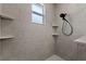 Modern shower with gray tile and sleek fixtures and three small shelves at 7191 Old Melbourne Hwy, St Cloud, FL 34771