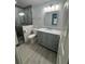 Modern bathroom featuring a gray vanity with marble top and a walk-in shower at 732 Palma Dr, Lady Lake, FL 32159
