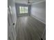 Bright bedroom featuring gray vinyl plank flooring and large window at 732 Palma Dr, Lady Lake, FL 32159