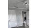 Bedroom featuring two doors, gray vinyl plank flooring and a ceiling fan at 732 Palma Dr, Lady Lake, FL 32159