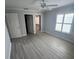 Bright bedroom featuring gray vinyl plank flooring and a closet at 732 Palma Dr, Lady Lake, FL 32159