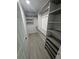 Walk-in closet featuring multiple shelves, gray vinyl plank flooring and white walls at 732 Palma Dr, Lady Lake, FL 32159