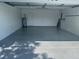 Spacious two-car garage featuring an epoxy floor with ample room for parking and storage at 732 Palma Dr, Lady Lake, FL 32159