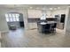 Bright, open kitchen features a large island with marble countertop, stainless steel appliances, and gray vinyl plank flooring at 732 Palma Dr, Lady Lake, FL 32159