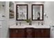 Well-lit bathroom featuring double sinks, a vanity, and modern finishes at 8625 Vista Point Cv, Orlando, FL 32836