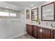 Bright bathroom featuring double sinks, a glass shower, and modern finishes at 8625 Vista Point Cv, Orlando, FL 32836