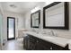 Bathroom featuring a double vanity with stone countertop and dark wood cabinets at 8625 Vista Point Cv, Orlando, FL 32836