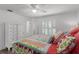 Bedroom with a floral quilt, plantation shutters, and a ceiling fan at 8625 Vista Point Cv, Orlando, FL 32836