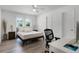 Bedroom features wood floors, ceiling fan, window, and a desk area at 8625 Vista Point Cv, Orlando, FL 32836