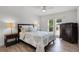 Bedroom featuring wood floors, ceiling fan, window and furniture at 8625 Vista Point Cv, Orlando, FL 32836