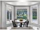 Bright breakfast nook with views of the pool and backyard through large bay windows at 8625 Vista Point Cv, Orlando, FL 32836