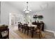Dining room with modern light fixture, dining table, wine rack and view of front door at 8625 Vista Point Cv, Orlando, FL 32836