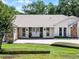 Close up of charming single-story home with white siding, brick accents, and a paver driveway at 8625 Vista Point Cv, Orlando, FL 32836