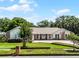 Charming single-story home with a manicured lawn, brick accents, and a paver driveway creating curb appeal at 8625 Vista Point Cv, Orlando, FL 32836