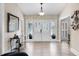 Inviting foyer featuring a double door entry, decorative wall paper and hard wood flooring at 8625 Vista Point Cv, Orlando, FL 32836