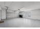 Spacious garage with epoxy floors, windows and an automatic garage door at 8625 Vista Point Cv, Orlando, FL 32836