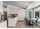 Bright kitchen featuring stainless steel appliances, light cabinetry and an adjacent breakfast nook at 8625 Vista Point Cv, Orlando, FL 32836