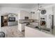 Well-lit kitchen featuring bright white cabinets, gray countertops, and modern stainless steel appliances at 8625 Vista Point Cv, Orlando, FL 32836