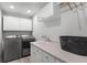 Laundry room featuring a sink, cabinets, and modern washer and dryer at 8625 Vista Point Cv, Orlando, FL 32836
