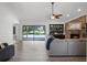 Bright living room with sliding glass doors to the patio, a fireplace and hardwood floors at 8625 Vista Point Cv, Orlando, FL 32836