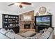 Cozy living room features a brick fireplace, a ceiling fan and comfortable seating at 8625 Vista Point Cv, Orlando, FL 32836