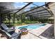 A beautiful backyard featuring a pool, stone fire pit, and Adirondack chairs, perfect for outdoor entertaining at 8625 Vista Point Cv, Orlando, FL 32836