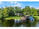 Picturesque waterfront property with a covered boat dock and lift at 8625 Vista Point Cv, Orlando, FL 32836