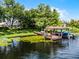 Lush backyard overlooking a calm waterfront, complete with a private dock and a boat lift at 8625 Vista Point Cv, Orlando, FL 32836