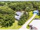 Aerial view of home showing new roof, adjacent building and lots of trees and landscaping at 9642 Florida Boys Ranch Rd, Clermont, FL 34711