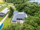 Home with a new gray roof, a spacious brick patio, and a lush, tree-filled yard at 9642 Florida Boys Ranch Rd, Clermont, FL 34711