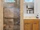 Updated bathroom with accessible shower, marble tiles and wood vanity with ample storage at 9642 Florida Boys Ranch Rd, Clermont, FL 34711