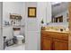 Cozy bathroom featuring a toilet, vanity, and charming decorative elements at 9642 Florida Boys Ranch Rd, Clermont, FL 34711