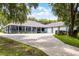 Lovely single-story home with a spacious front yard, covered porch, mature trees, and a long driveway at 9642 Florida Boys Ranch Rd, Clermont, FL 34711