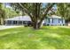 Beautiful home with a sprawling green lawn, and mature trees, offering a sense of privacy and tranquility at 9642 Florida Boys Ranch Rd, Clermont, FL 34711