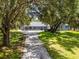 Stunning single-story home with a covered front porch, surrounded by mature trees and a well-manicured lawn at 9642 Florida Boys Ranch Rd, Clermont, FL 34711