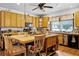 Spacious kitchen features an island, wood cabinets, a farmhouse sink, and lots of counter space at 9642 Florida Boys Ranch Rd, Clermont, FL 34711