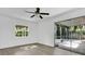 Well-lit bedroom showcasing wood-look floors and sliding doors leading to a screened in porch at 1148 Northcrest Dr, Apopka, FL 32703