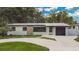 Charming single-story home with stone accents, a garage, and an expansive front yard at 1148 Northcrest Dr, Apopka, FL 32703