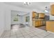Open kitchen area, tile flooring, wood cabinets, and adjacent to living and dining spaces at 1148 Northcrest Dr, Apopka, FL 32703