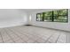 Bright living room with tile floors and a large window overlooking the backyard at 1148 Northcrest Dr, Apopka, FL 32703